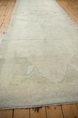 Subtle antique ivory and sea foam green floral pattern of hand-knotted Oushak rug pile.