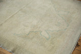Vintage Oushak rug pile showing subtle sea foam green floral pattern on antique ivory.