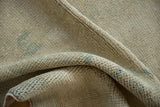 Hand knotted rug foundation, showing tight weave and subtle blue-green dye.
