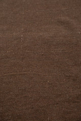 Chocolate brown natural wool texture showing subtle inflections on this vintage Moroccan Kilim.