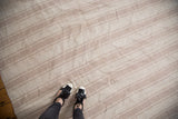 Surface of hand woven Turkish flatweave rug with varying ivory and beige stripe widths.