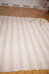 Visible texture of the hand-woven Turkish vintage flatweave rug, featuring ivory and beige stripes.
