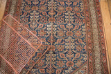 Repeating Henna plant design on vintage Malayer rug with aged indigo and terra cotta tones.