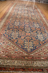 Vintage Malayer runner detail: indigo henna pattern, aged terra cotta border, and secure fringe.