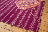 Vintage Moroccan Kilim runner, showcasing varied mauve and gray stripes with tasseled edge.