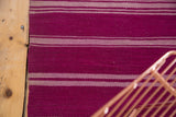 Detail of the vintage Moroccan Kilim rug runner with horizontal aubergine and gray banded stripes.