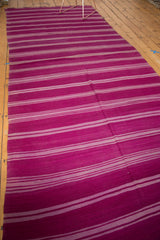 Handwoven texture of the Moroccan Kilim runner with repeating mauve and gray striped bands.