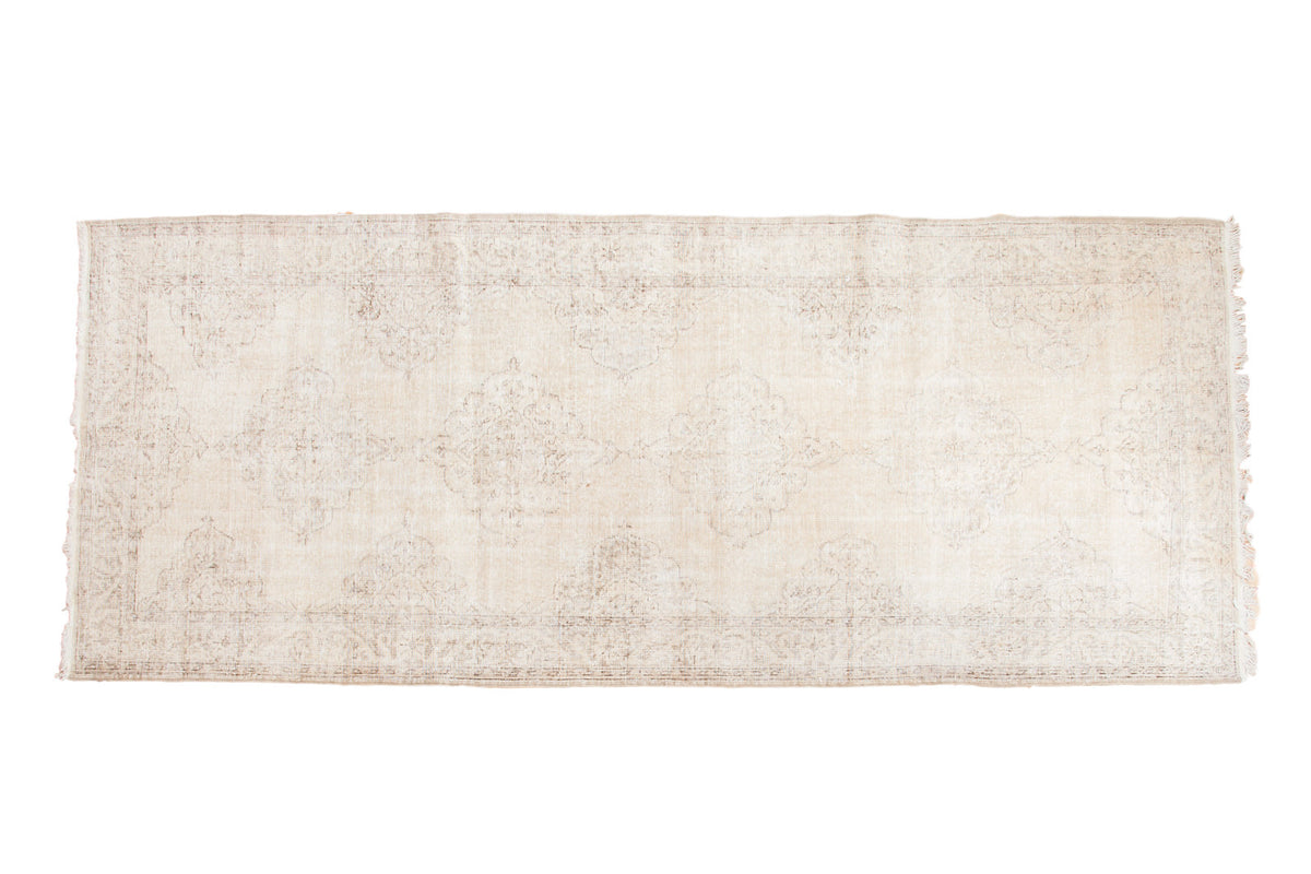 Distressed vintage Sparta runner rug, faded ivory and beige allover medallion pattern, 4'10"x10'11".