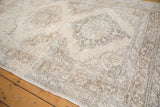Vintage Sparta rug showing distressed hand-knotted pile with ivory, beige, and pewter lattice medallion pattern.