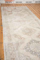 Distressed ivory and beige Sparta runner, showing its lattice oriented staggered medallion pattern.