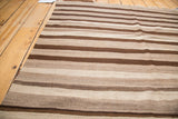 Striated pattern of natural un-dyed beige, light coffee, and dark brown Kilim.