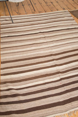 Rhythmic striated weaving of natural beige, coffee, and chocolate brown Moroccan Kilim.
