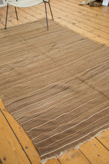 Striated flat weave with natural wool fringe at a vintage Moroccan Kilim rug end.