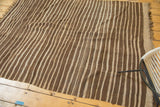 Vintage Moroccan flat weave Kilim rug with natural brown and beige striated stripes.