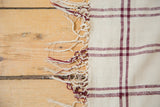 Hand woven ivory and wine red fringe detail from a vintage Moroccan plaid rug.