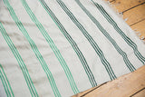 Mint green to charcoal banded stripe transition on vintage Turkish throw cloth.