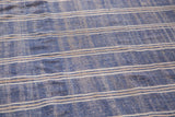 Hand-woven Moroccan Kilim surface, denim blue, ivory, beige horizontal stripes and tinsel accents.
