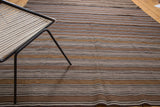 Hand woven, geometric flat weave with striated natural brown and beige tones.