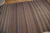 Flat weave Moroccan Kilim carpet with rich brown, coffee, and beige striated stripes.
