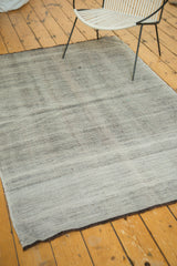 Thick flatwoven texture with subtle herringbone pattern and charcoal brown edge.