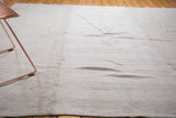 Textured natural beige vintage Turkish Grainsack flat weave rug showing vertical seam.