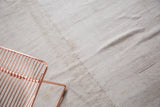Textured hand woven vintage grainsack flat weave showing natural hemp and stitched seam.