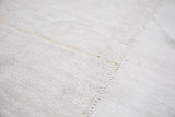 Light beige vintage grainsack flat weave showing a clear stitched seam.