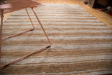 Vintage Moroccan flatweave rug, textured horizontal ivory and caramel stripes, scattered spots.