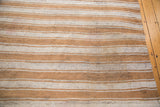 Textured Moroccan flatweave with ivory, caramel, and speckled wool stripes.