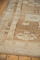Vintage Oushak runner's serrated leaf border and field in ivory, sand, and bronze.