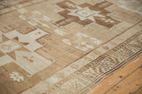 Secured side border of vintage Oushak runner with bronze and ivory geometric patterns.