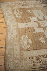 Hand-knotted vintage Oushak runner border, highlighting serrated leaf motif and ivory-sand abrashes.