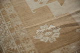 Hand knotted Turkish Oushak rug pile with ivory, sand, and bronze abrashes and intricate leaf motif.