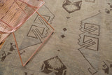 Minimalist charcoal brown geometric pattern with faded sea foam green and ivory on vintage Oushak rug.