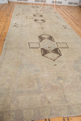 Hand-knotted pile texture of vintage Oushak runner, showing subtle blanched pastel hues.