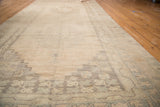 Vintage Oushak rug with striated abrashes and subtle geometric border motifs.