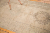 Traditional Oushak runner with faded medallion, striated abrashes, and muted tones.