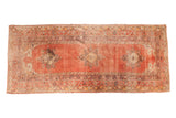 Vintage Turkish Oushak runner with triple scalloped medallions on a faded cinnabar red field.