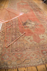 Faded cinnabar red field with blanched tangerine orange rectilinear medallion and thin pile.