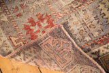 Hand-knotted foundation and faded geometric patterns of a Vintage Oushak rug corner.