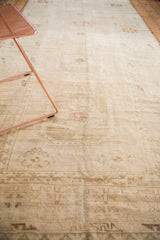 Vintage Oushak runner detail: hand-knotted texture with antique ivory starburst motifs, faded bronze, and abrash.