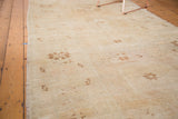 Vintage Oushak runner detail: faded bronze starburst motifs on antique ivory with abrash.