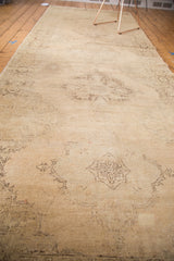 Distressed vintage Sparta runner with faded beige and peach scalloped medallions, showing abrash.