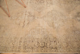 Distressed beige and light peach field with faded charcoal medallion pattern and border on a vintage Sparta runner.