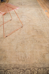 Distressed beige field of a vintage Turkish Sparta runner with faded charcoal motifs.
