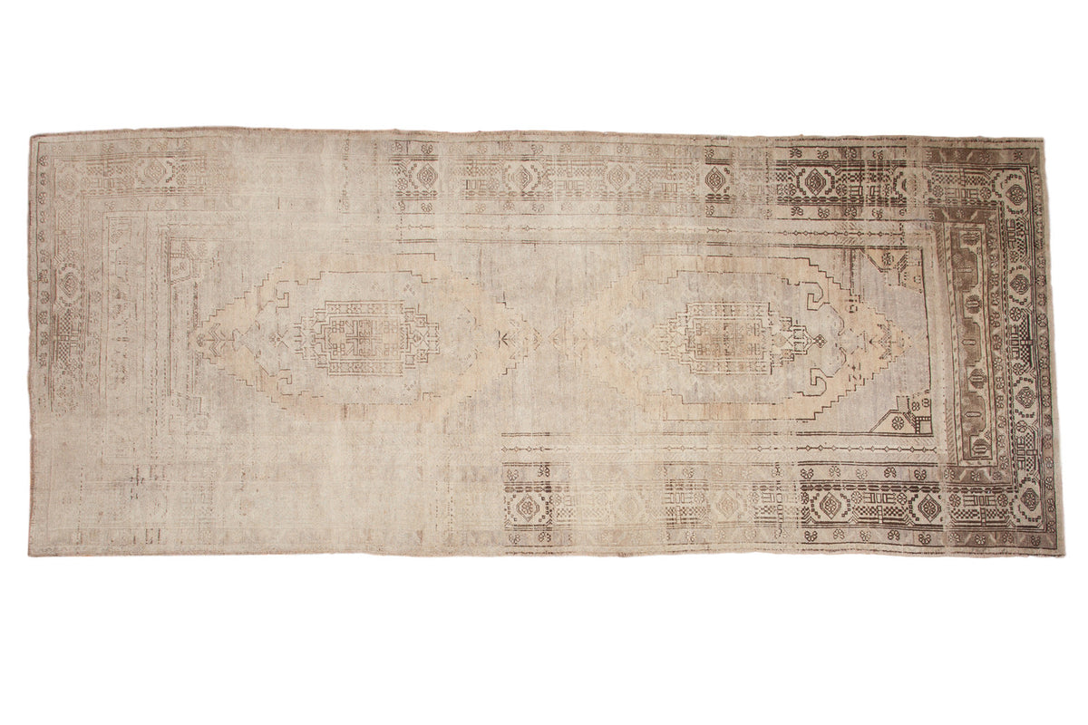 Vintage Oushak runner with oblong geometric medallions, open field, and beige charcoal abrashes.