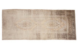 Vintage Oushak runner with oblong geometric medallions, open field, and beige charcoal abrashes.