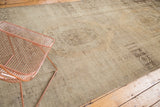 Vintage Oushak rug runner featuring geometric stylized medallions and heavy abrashes in beige and sand.