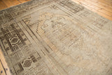 Vintage Oushak runner's stylized geometric patterns with heavy abrashes on a beige and brown field.