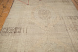 Detail of vintage Oushak rug's geometric pattern in beige, sand, and charcoal with heavy abrashes.